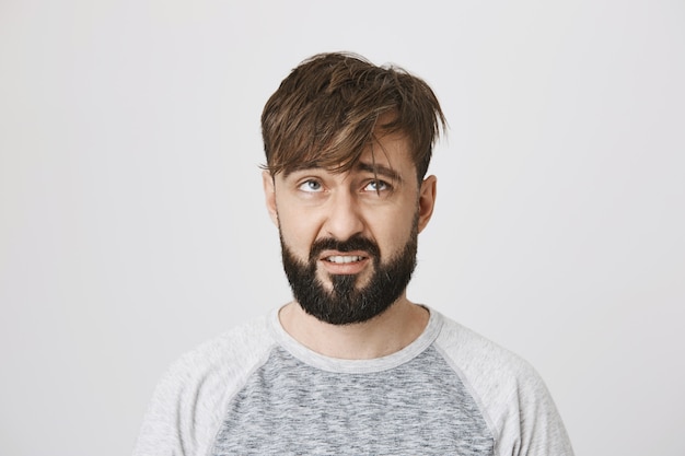 Gloomy messy bearded guy with tossed hair