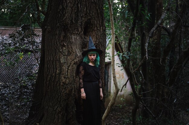 Gloomy witch in dark forest