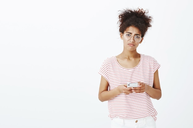 Free photo gloomy woman with afro hairstyle posing in the studio