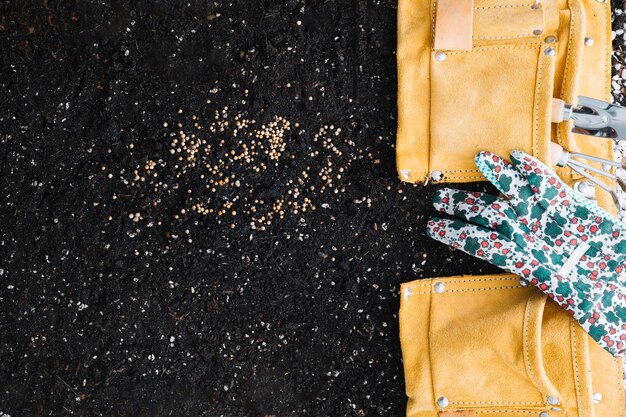 Glove on bag with gardening tools