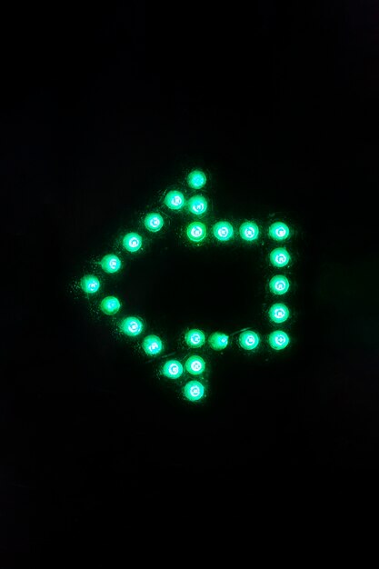 Glowing arrow sign in the dark