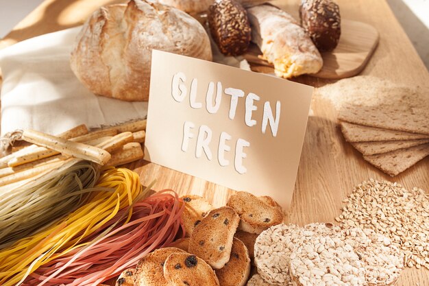 Gluten free food. Various pasta, bread and snacks on wooden background from top view. Healthy and diet concept.