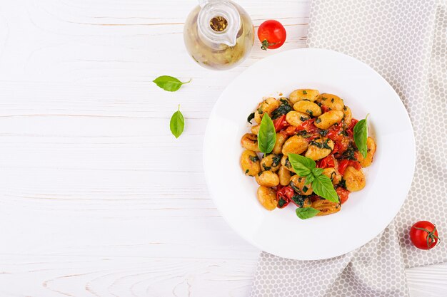 Gnocchi pasta in rustic style.  Italian cuisine. Vegetarian vegetable pasta. Cooking lunch. Gourmet dish. Top view