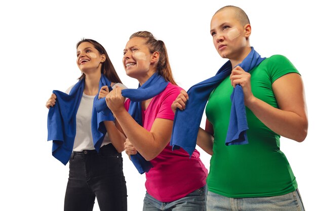 Goal. Female soccer fans cheering for favorite sport team with bright emotions isolated on white studio background.