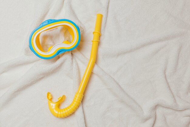 Goggles and tube on white towel