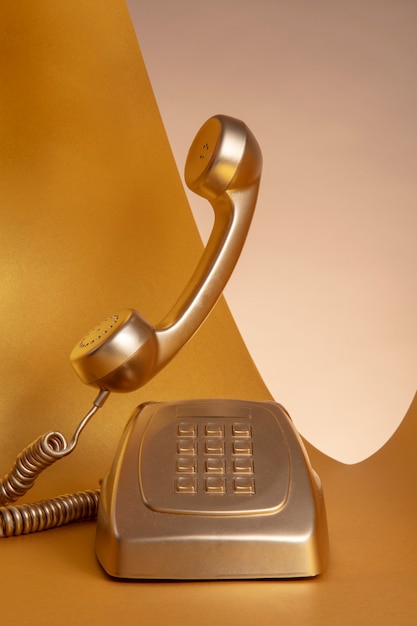 Gold aesthetic wallpaper with old telephone