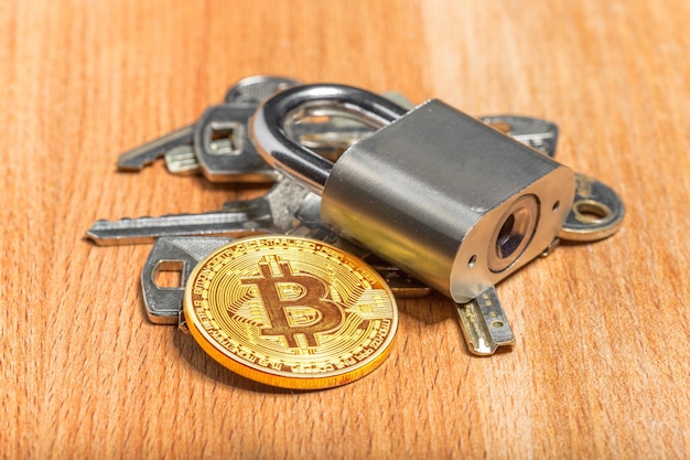 Gold bitcoin and padlock