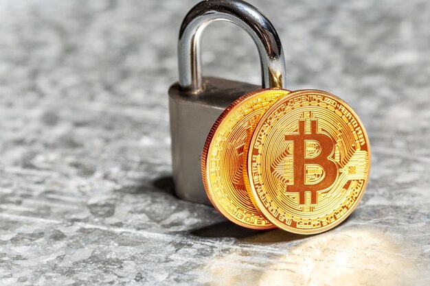 Gold bitcoin and padlock
