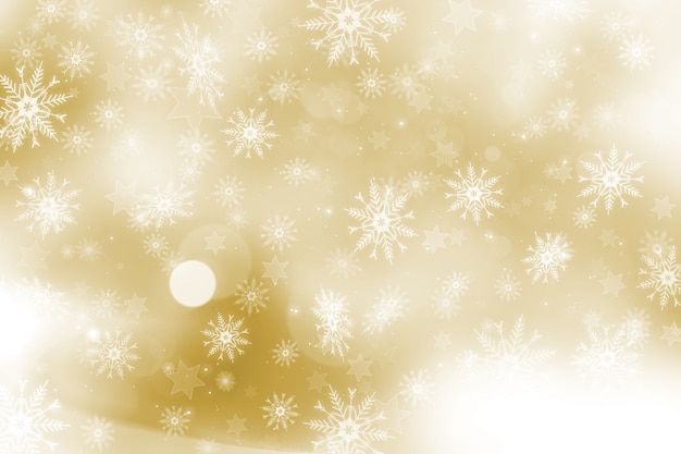 雪片と星のデザインとゴールドのクリスマスの背景