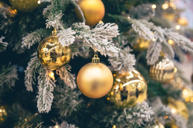 Gold christmas decorations on the christmas tree closeup