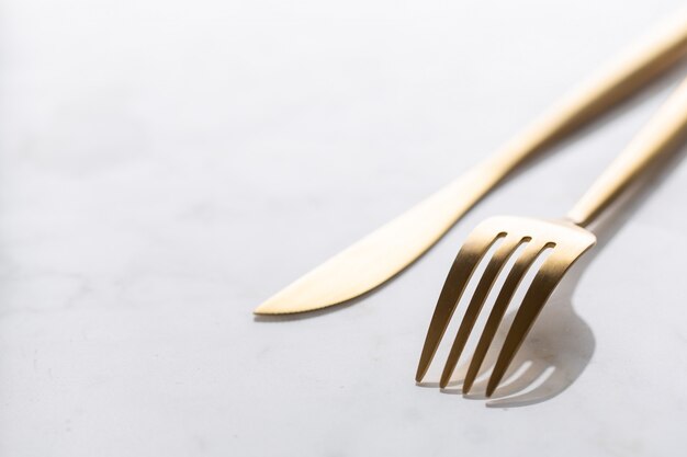 Gold cutlery set on marble 