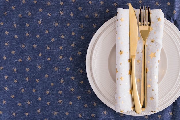 Gold fork and knife on plate 