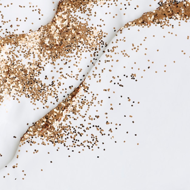 Free photo gold glitter on white background