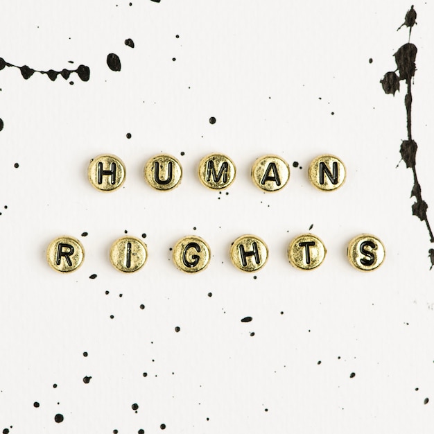 Gold human rights word beads