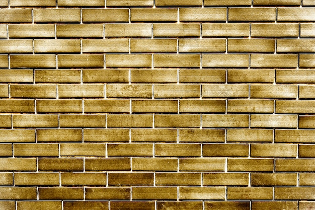 Free photo gold painted brick wall textured