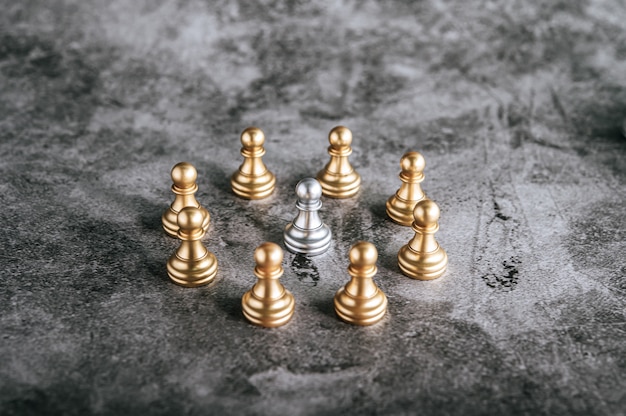 Gold and silver chess on chess board game for business metaphor leadership concept