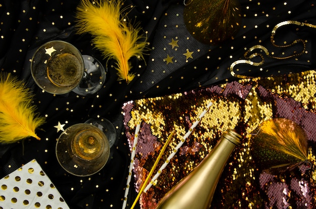 Golden background with champagne glasses flat lay