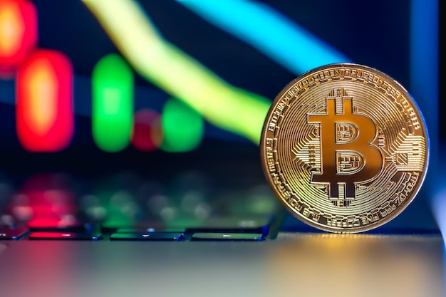 Golden Bitcoin coin on keyboard Stock market trading chart online candlestick