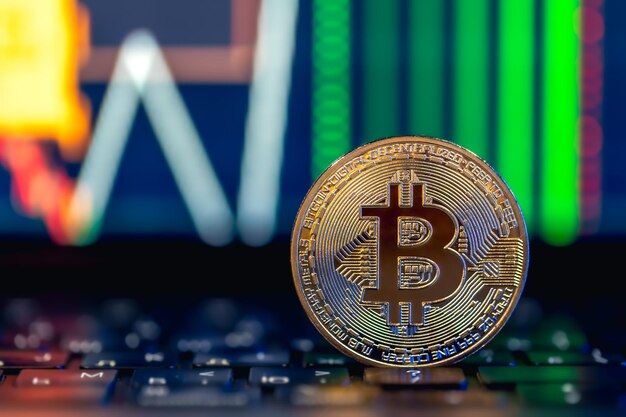 Golden Bitcoin coin on keyboard Stock market trading chart online candlestick