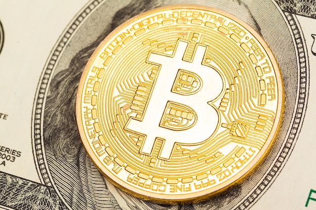 Free photo golden bitcoin on dollar