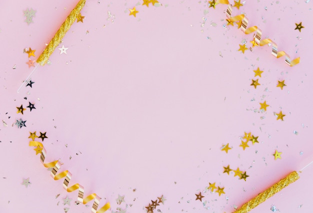 Golden candles and glitter frame with copy space on pink background