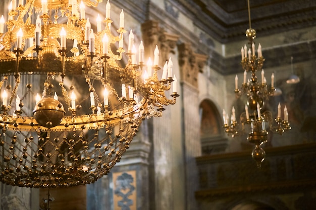 Golden chandelier hangs from the ceiling in church