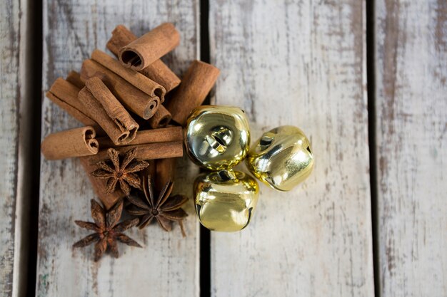 Golden christmas decoration on a wooden table with cinnamon