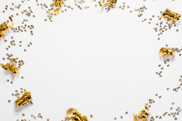 Golden circular confetti frame top view