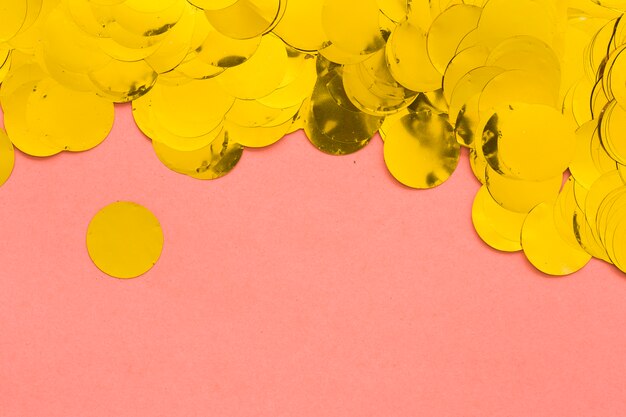 Golden confetti on pink
