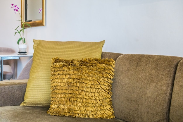 Free photo golden cushions on the sofa