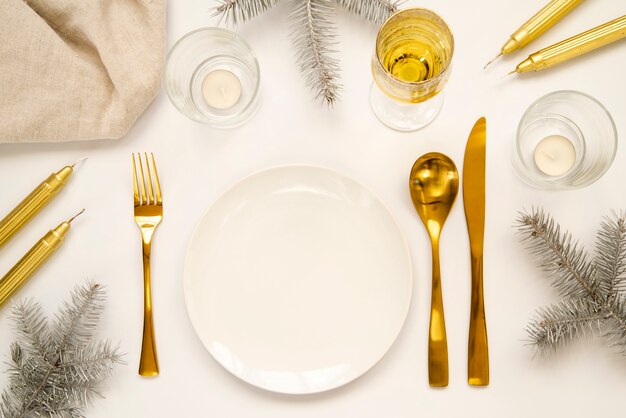 Golden cutlery and copy space plate