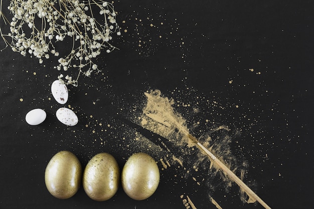 Golden eggs near flowers