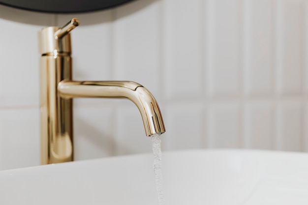 Golden faucet with running water