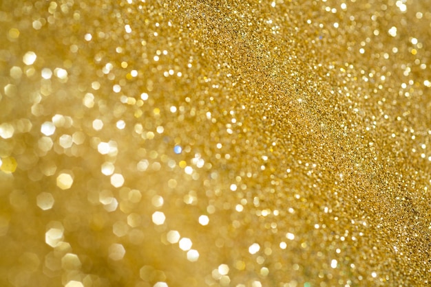 Golden giltter. background for celebration card. glowing backdrop.