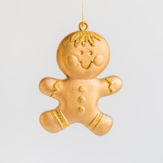 Golden gingerbread ornament on white background