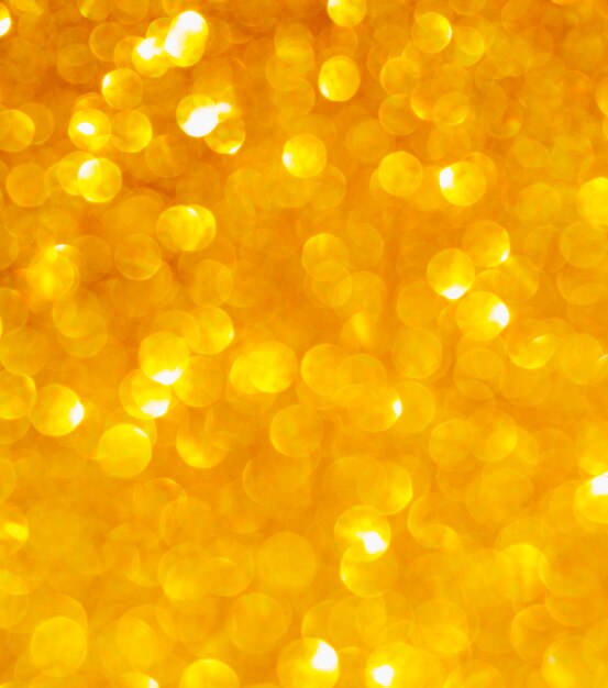 Golden glitter close-up background unfocused