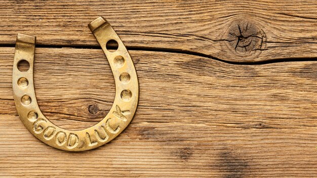 Golden horseshoe on wooden background