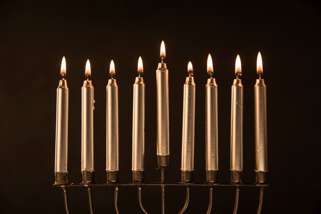 Golden menorah with flaming candles