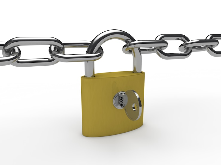 Free Photo golden padlock with a chain and a key