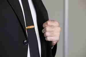 Free photo golden pin on the tie of a man