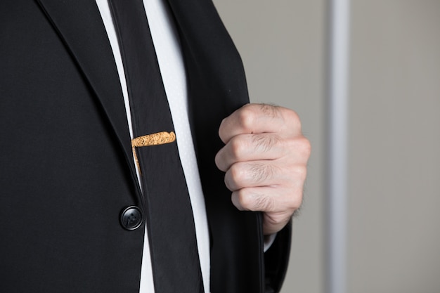 Golden pin on the tie of a man