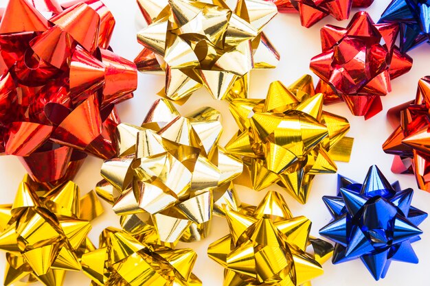 Golden; red and blue decorative ribbons on white backdrop