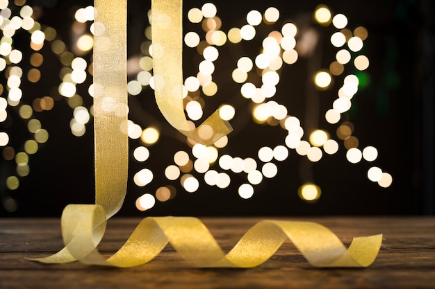 Golden ribbon hanging near abstract lights