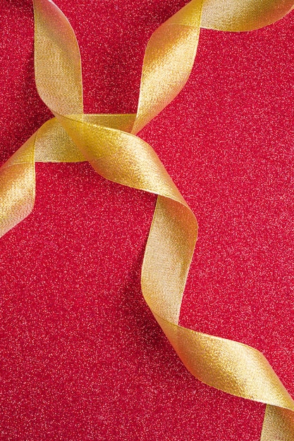 Golden ribbons on red background