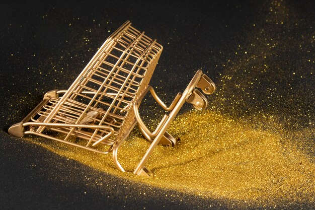 Golden shopping cart on black background
