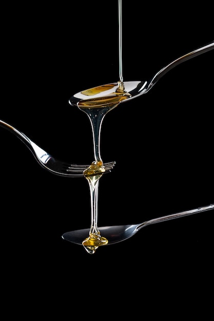 golden sweet honey dripping from spoon 