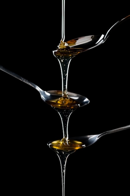 golden sweet honey dripping from spoon 