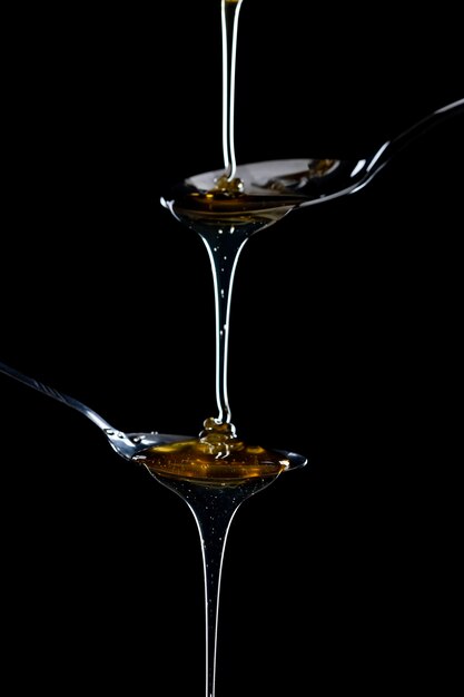 golden sweet honey dripping from spoon 