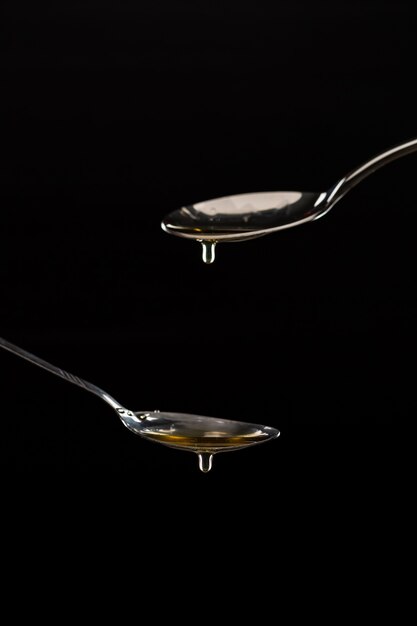 golden sweet honey dripping from spoon 