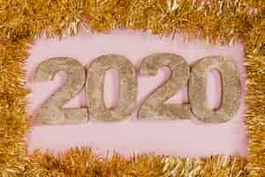 Free photo golden tinsel frame with new years sign